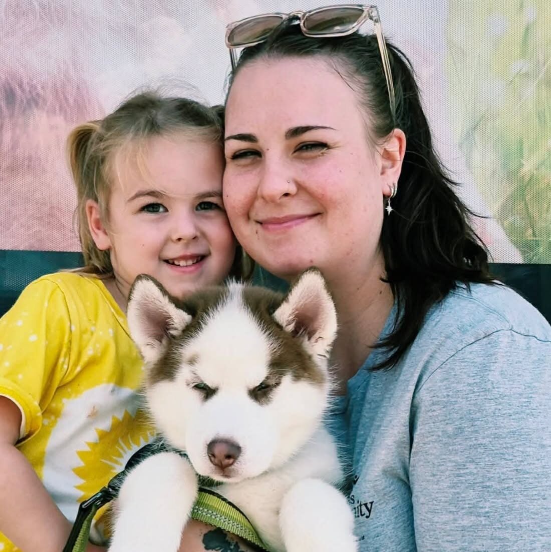 A mother and child welcoming their new puppy